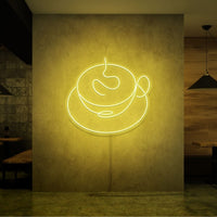 Neonlamp van een kop koffie in kleur geel