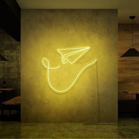 Neonlamp van papieren vliegtuig in kleur geel