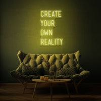 Neon letters met tekst "create your own reality" in kleur geel