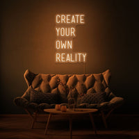Neon letters met tekst "create your own reality" in kleur oranje