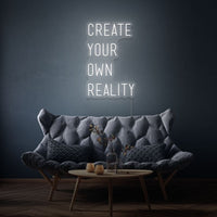 Neon letters met tekst "create your own reality" in kleur wit
