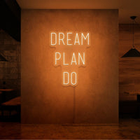 Neon letters met tekst "Dream plan do" in kleur oranje