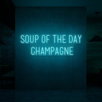 Neon letters met tekst "Soup of the day: champagne" in kleur cyaan