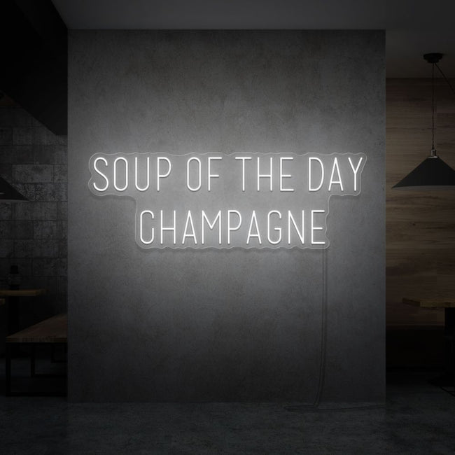 Neon letters met tekst "Soup of the day: champagne" in kleur wit