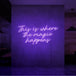 Neon letters met tekst "This is where the magic happens" in kleur paars
