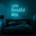 Neon letters in tekst "You beautiful mess" in kleur cyaan
